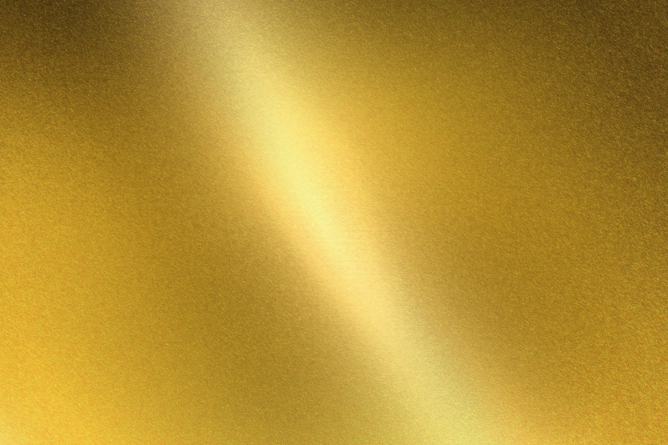 Light shining on gold metal sheet, abstract texture background